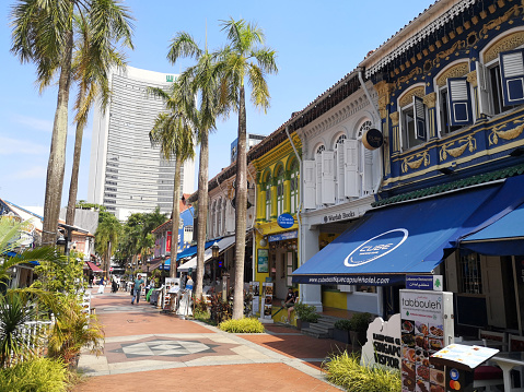 Local people walking at Bussorah pedestrian street mall in Kampong Glam, Singapore.