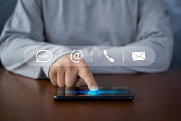 istock Contact us or Customer support hotline people connect. Businessman using smart phone and touching on virtual screen contact icons 1438843801
