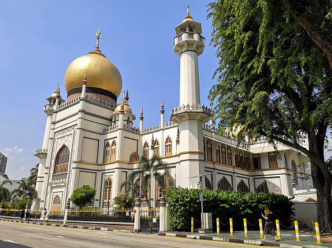 People walking in Kampong Glam by the Masjid Sultan (Sultan Mosque), Singapore.