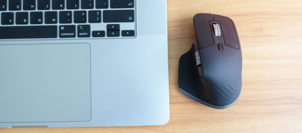 istock Ergonomic vertical mouse with laptop computer on adjustable desk at workplace, prevention wrist pain. De Quervain s tenosynovitis, Intersection Symptom, Carpal Tunnel or Office syndrome concept 1438845231