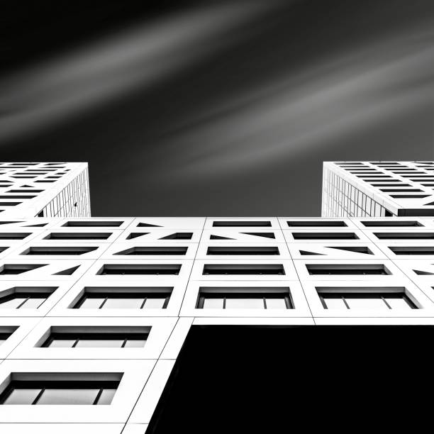 istock Low angle shot of a white skyscraper under a dark sky 1438845957