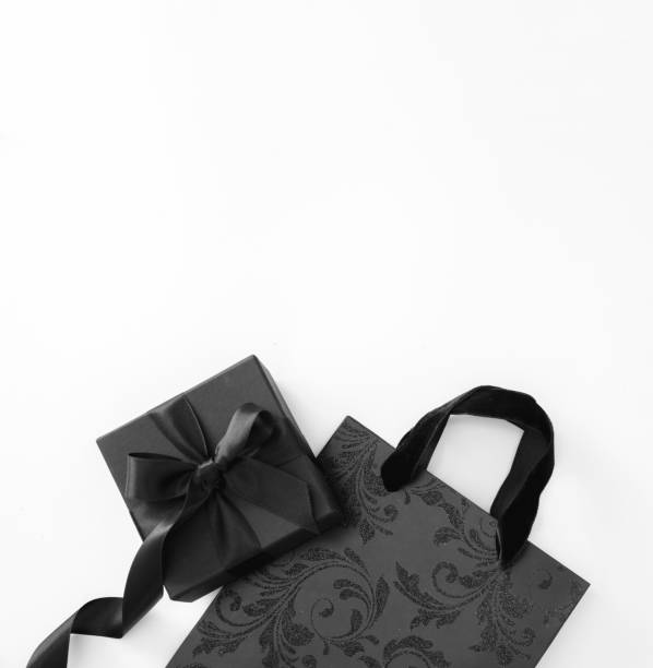 istock Black Friday sale concept. Shopping bag and gift box on white, copy space 1438854853