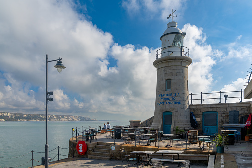 Folkestone, United Kingdom - 11 September, 2022: the Folkestone Harbor arm with the historic lighthouse
