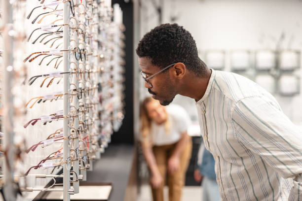 istock Mature Man Selecting Eyeglasses In An Optical Store 1438856932