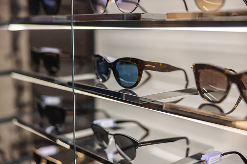 Variety of modern sunglasses at the optician store.