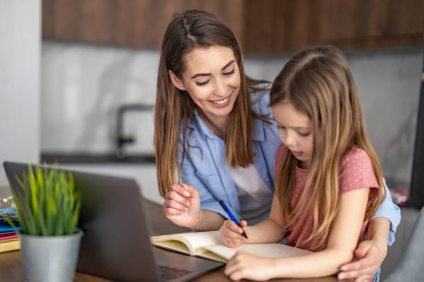 istock Mom helping kid with homework 1438859023