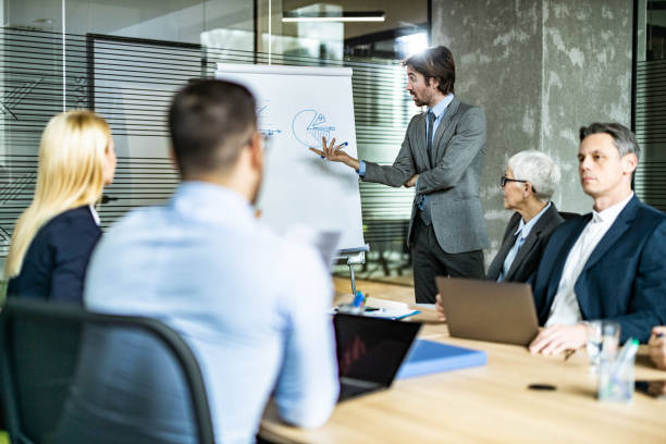 istock Young businessman leading a presentation in the office. 1438859633