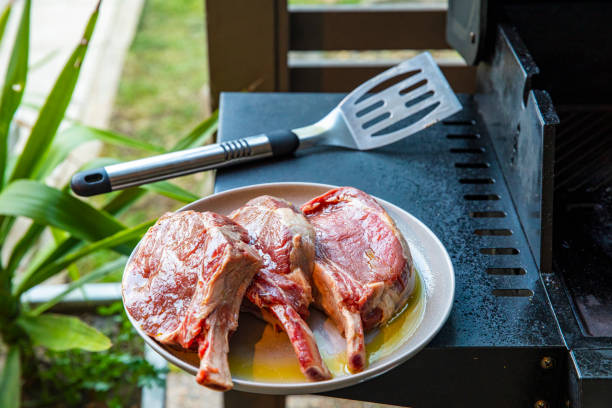 Thick cut steak prepared to cook on barbecue grill