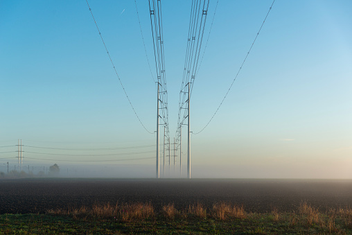 Pylons at dawn in the fog, the netherlands