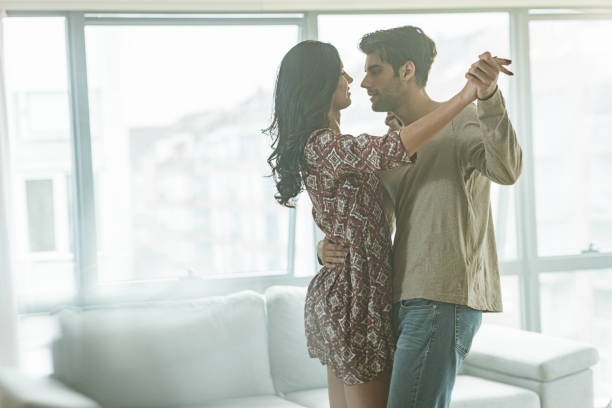 istock Romantic couple having fun while dancing in the living room. 1438860603
