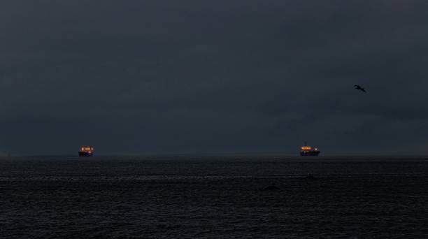 istock Beautiful night view of two ships in a calm ocean 1438862759