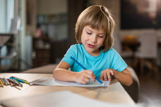 istock Cute little boy drawing at home. 1438863366