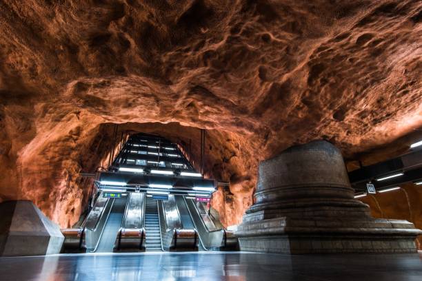istock Low angle shot of modern architectural design with an escalator in a subway train station 1438863726