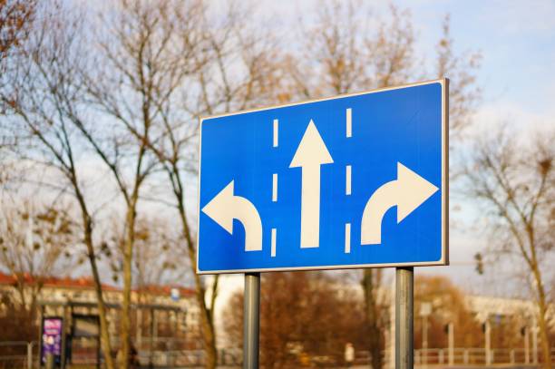istock Threeway blue sign on the side of a road at daytime 1438863942
