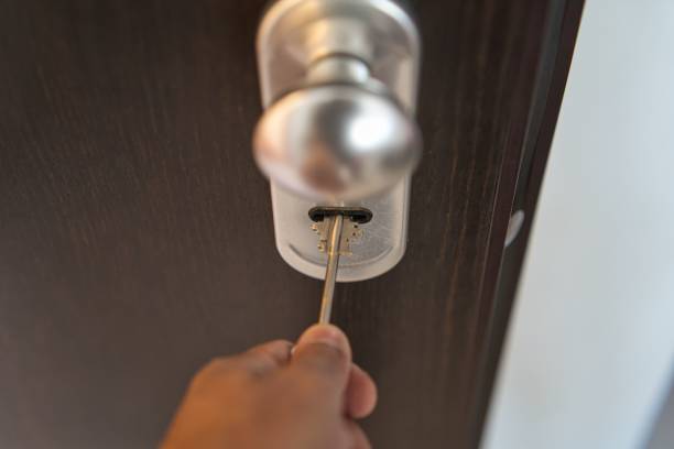 istock Hand with a key trying to open the door 1438864512