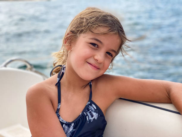 istock Girl looking smiling at camera on a boat 1438865010