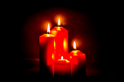 copy space concept with four flowing red burning candles