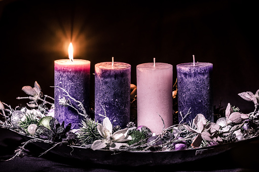 advent cristian concept with 1 pink candle and 3 purple candles