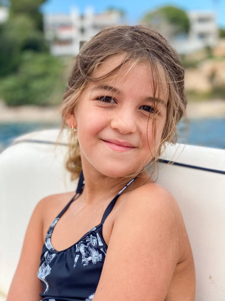 istock Girl looking smiling at camera on a boat 1438867223