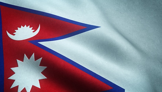 A closeup shot of the waving flag of Nepal with interesting textures