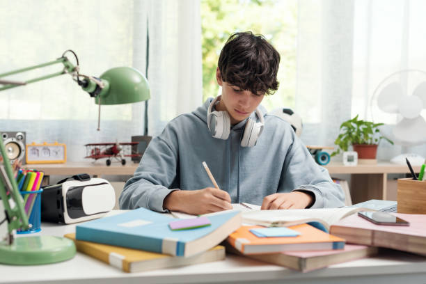 istock Teenager studying at home alone 1438867686