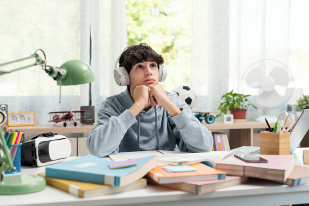 istock Student doing homework and listening to music 1438867776
