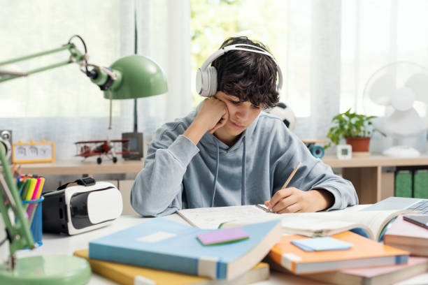 istock Student listening to music and doing homework 1438867833
