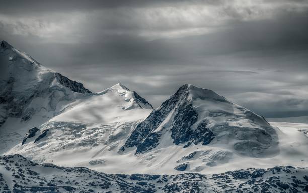 istock Beautiful scenery of a mountain range covered with snow under the cloudy sky 1438867986