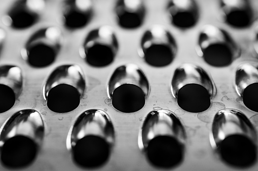 Black and white macro of angled cheese grater