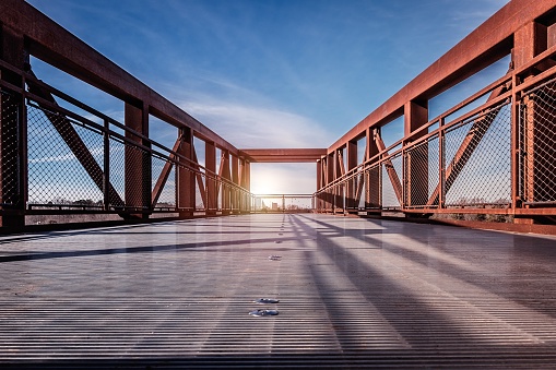 A beautiful scenery of sun rays shining through a bridge in Winston Salem, North Carolina