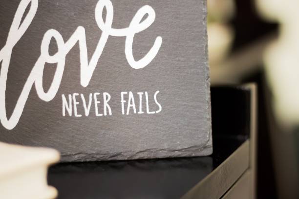 istock Grey Love never fails sign on a blurred background 1438868421