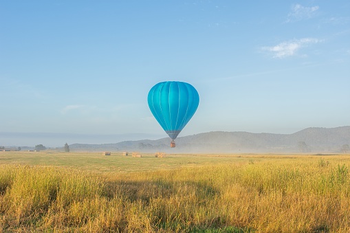 Colorful hot air balloon in flight over blue sky