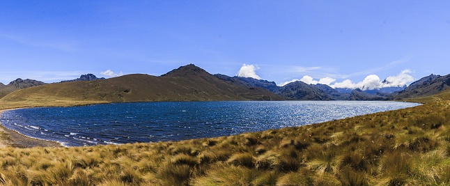 A beautiful scenery of Ozogoche lake in Ecuador surrounded by high rocky mountains