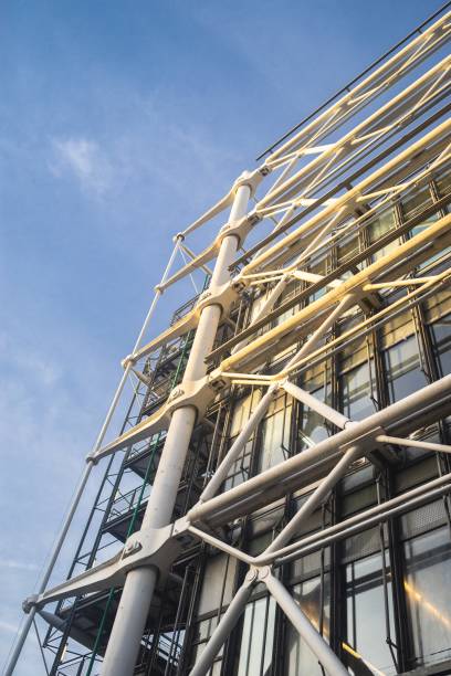 istock Low angle view of modern building construction under a blue sky and sunlight 1438871489