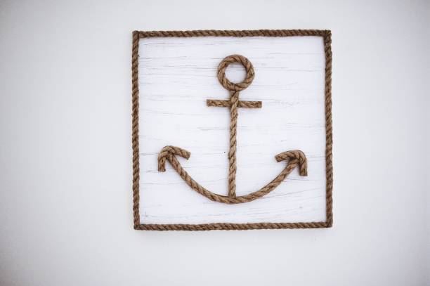 istock Anchor sign made from ropes on a white wooden wall 1438872422