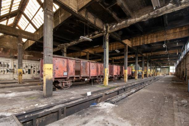 istock Interior shot of an old warehouse with old trains stored inside 1438872426