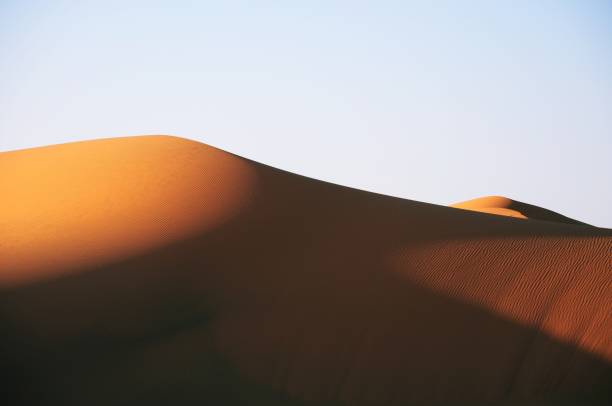 istock Beautiful view of a desert during sunset under a light blue sky 1438872691
