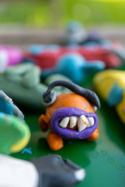 istock Vertical view of an orange-colored clay monster character 1438872889