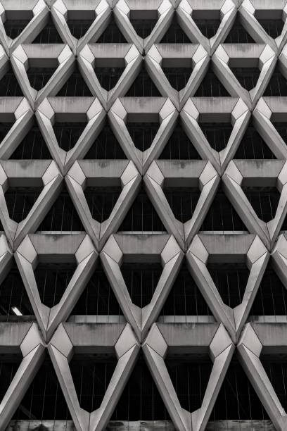 istock Greyscale of modern architecture with metallic walls under the lights 1438873255