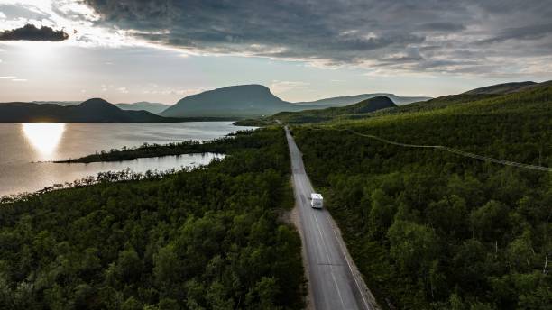 RV driving towards the Saana fell Aerial view of a rv driving towards the Saana fell, sunny summer day, in Kilpisjarvi, Finland norrbotten province stock pictures, royalty-free photos & images