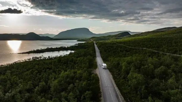 Aerial view of a rv driving towards the Saana fell, sunny summer day, in Kilpisjarvi, Finland