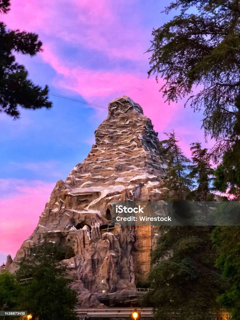 Vertical shot of the Matterhorn Bobsleds under sunset colorful sky in Anaheim, California A vertical shot of the Matterhorn Bobsleds under sunset colorful sky in Anaheim, California Anaheim - California Stock Photo