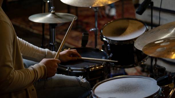 istock High angle shot of a person playing drums in a studio 1438873607