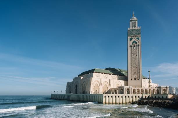 istock Hassan II Mosque surrounded by water and buildings under a blue sky and sunlight 1438874368