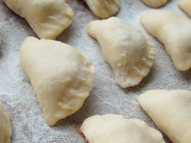 istock cooking. Dumplings with cheese. Ready for cooking dumplings with cottage cheese. 1438874948