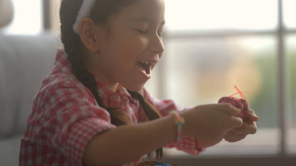 istock little girl sitting and drawing easter eggs 1438875480