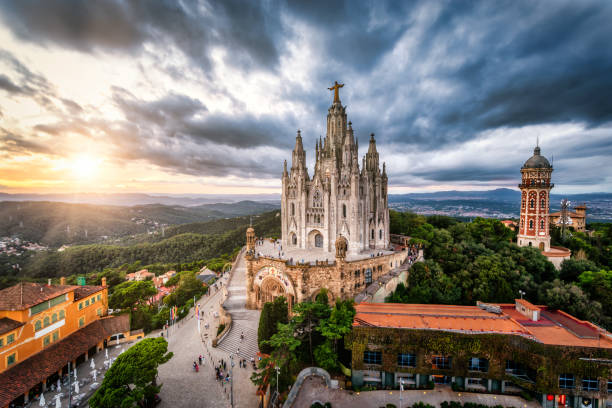 Expiatory Church of the Sacred Heart of Jesus in Tibidabo mountain, Barcelona Aerial view of temple of the Sacred Heart of Jesus, Mount Tibidabo at sunset, Barcelona, Spain. morning temple sun sunlight stock pictures, royalty-free photos & images