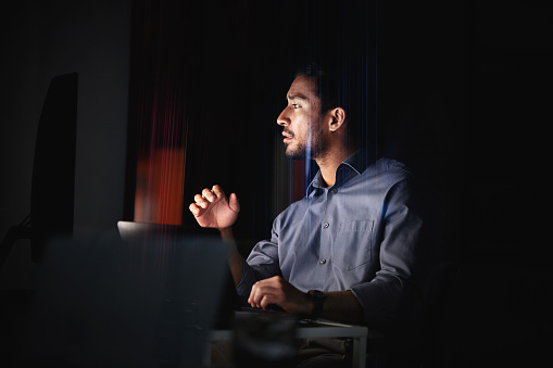 Dark room, computer and businessman with cyber security innovation, information technology server update and data analytics at night. IT engineer business man working on desktop pc for web solution