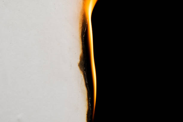 burning paper, glowing edge of paper on a black background burning paper, glowing edge of paper on a black background burnt paper stock pictures, royalty-free photos & images