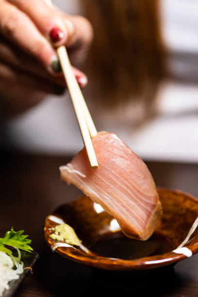 istock Picking up sashimi with chopsticks to eat 1438877998